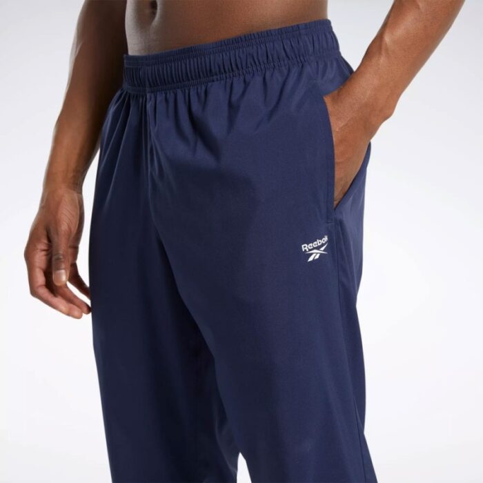 ⁦بنطلون ريبوك ويفن انلاين للرجال لون كحلي - Reebok Men's Training Essentials Woven Unlined Pants - Navy⁩ - الصورة ⁦6⁩