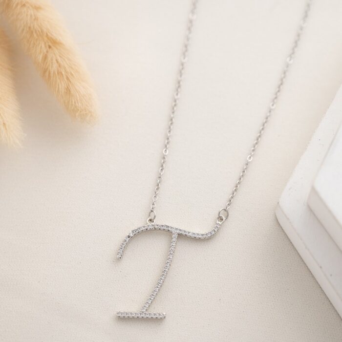 10334595_67dc4a9021ed4 سلسال فضي زركون بتصميم حرف T - الصورة 1