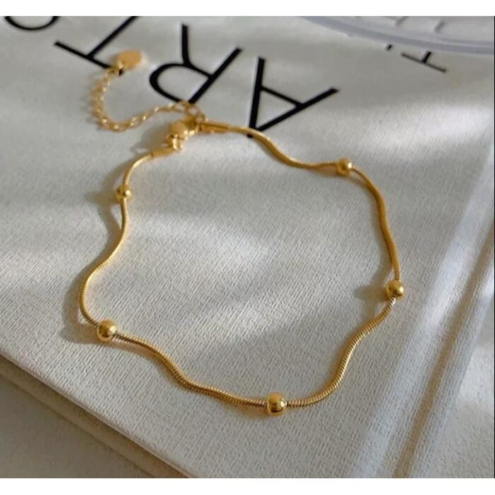 103374823_67dc62581f3fb خلخال ذهبي بتصميم طابات صغيرة - الصورة 1