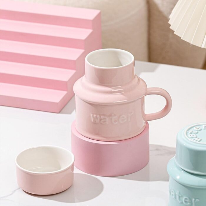 103375091_67dc6418ed8cc مج (كوب ) مع غطاء لون زهري بتصميم Water - الصورة 1