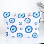 شنطة يد قماش للرحلات بتصميم عيون لون أبيض