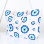 ⁦شنطة يد قماش للرحلات بتصميم عيون لون أبيض⁩ - الصورة ⁦2⁩