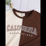 ⁦تيشيرت نص كم بتصميم لوس انجلوس للأطفال لون أبيض وبني⁩ - الصورة ⁦3⁩