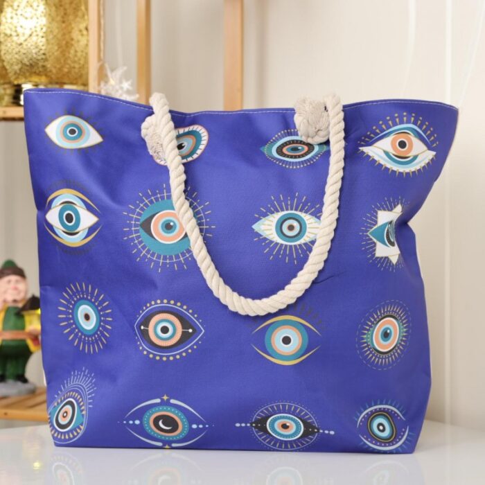 103378890_67de17be4aeb4 شنطة يد قماش للرحلات بتصميم عيون لون نيلي - الصورة 1