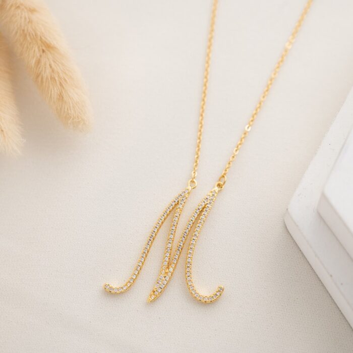 10334600_685e8566ad6ec سلسال ذهبي زركون بتصميم حرف M - الصورة 1