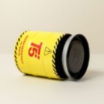 صندوق هدايا معدن شبابي للساعه شكل اسطوانه لون أصفر تفاصيل أحمر وأسود