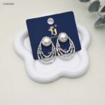 حلق من اللؤلؤ و يتدلى منه أنصاف اقمار على شكل صفوف من الزركون لون فضي