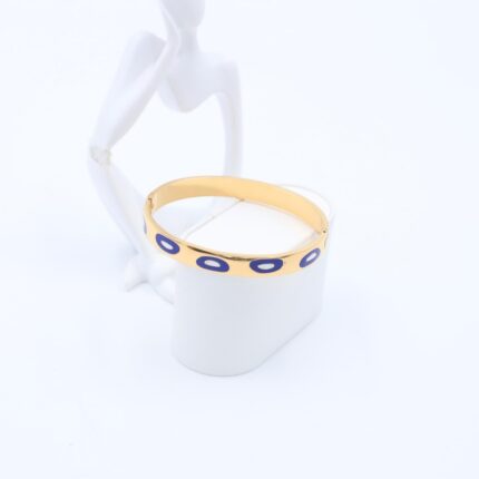 سوارعريض لون ذهبي بتصميم عيون أزرق