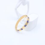 ⁦سوارعريض لون ذهبي مع عيون أزرق⁩ - الصورة ⁦2⁩